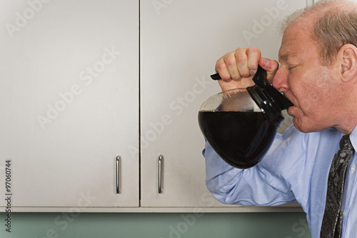 Fotografie Businessman drinking out of coffee pot