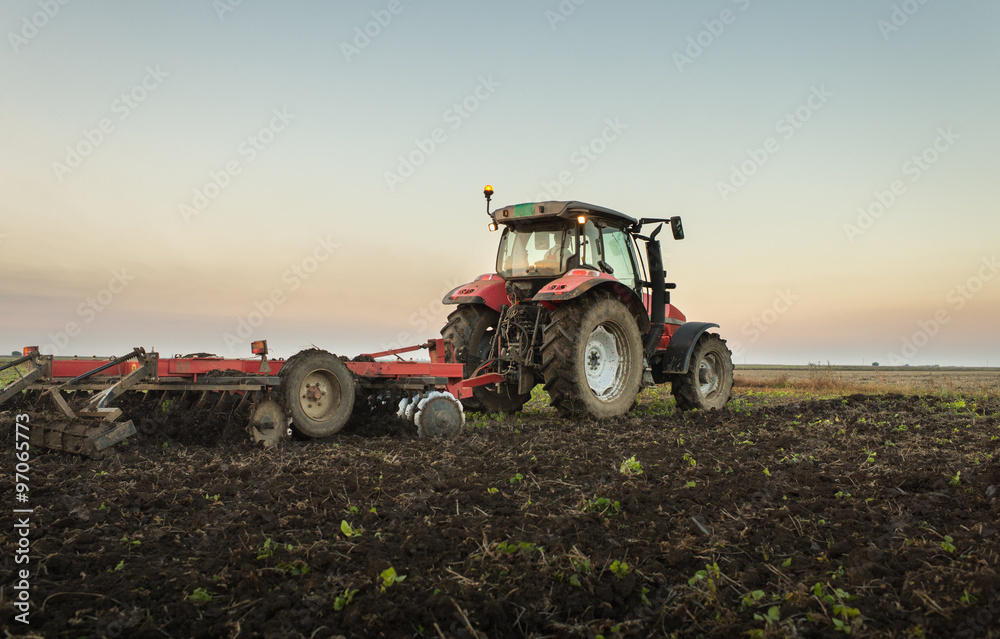 Fototapeta premium tractor plowing a field
