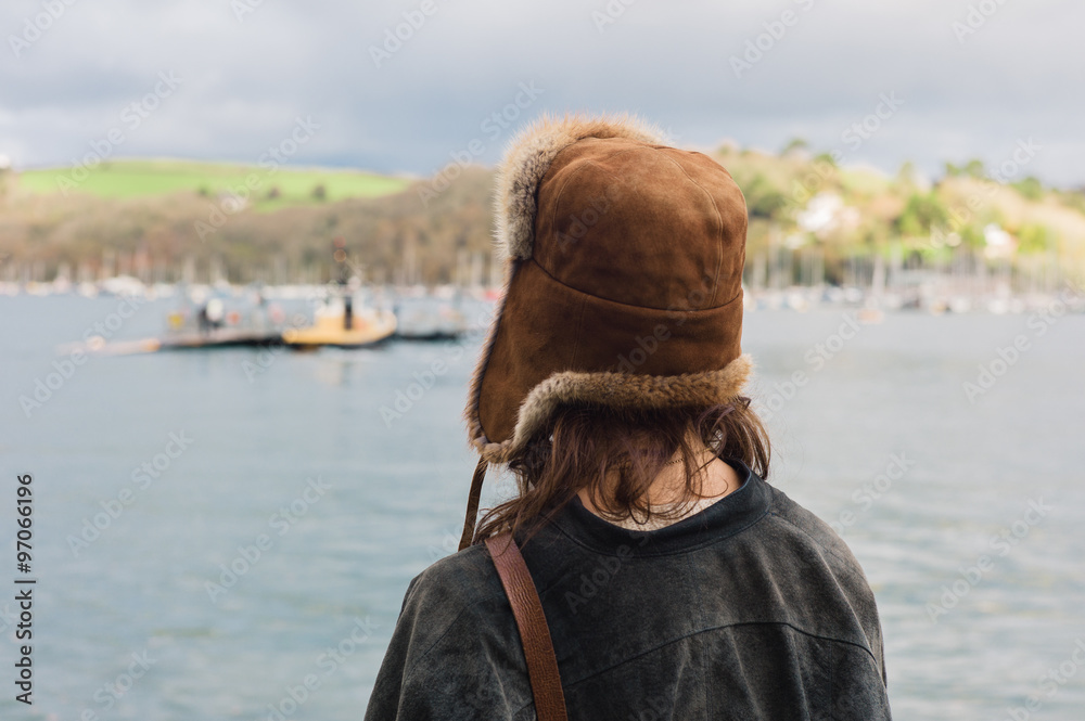Young woman standing by water in village Young woman standing by water in village