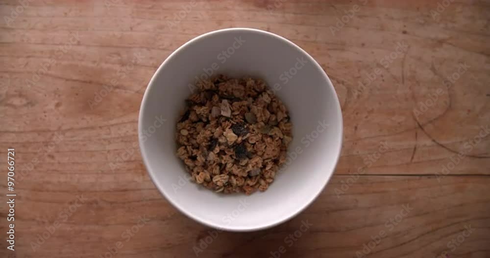 Point Of View Shot Of Pouring Muesli Into Bowl Point Of View Shot Of Pouring Muesli Into Bowl