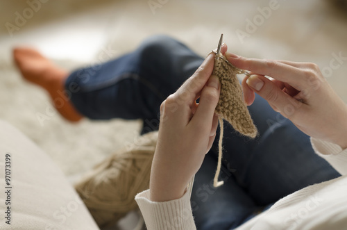 Hands of a young woman knitting. Closeup