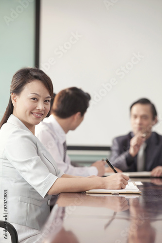 Businesswoman in Meeting Smiling At Camera