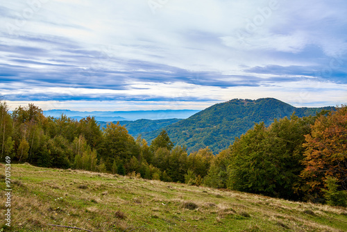 Mountain landscape with clouds and colorful trees