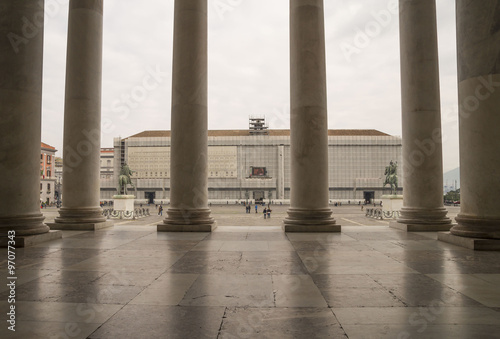 Gloomy day among the columns, at Church of San Francesco di Paola in Piazza del Plebiscito ,Naples, Italy . In front is the Royal Palace.
