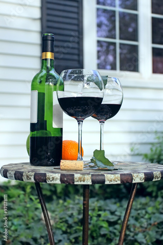 Bottle of Wine and glasses on a garden table