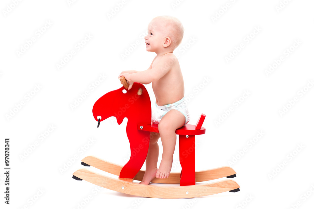 Baby on the toy horse or elk Baby on the toy horse or elk