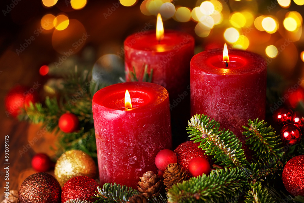 Three burning candles in festive christmas arrangement, 3. Advent