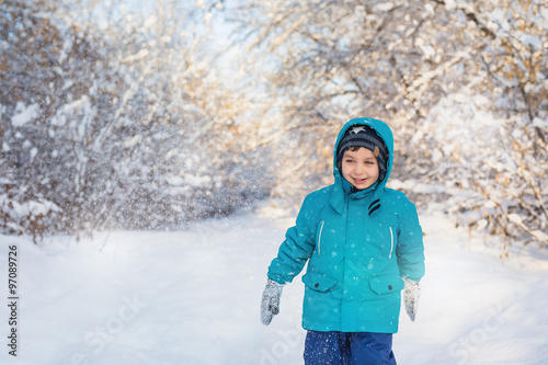 A cute little boy in winter park