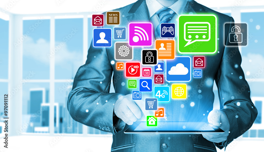 Obraz premium Business man using tablet PC with social media icon set