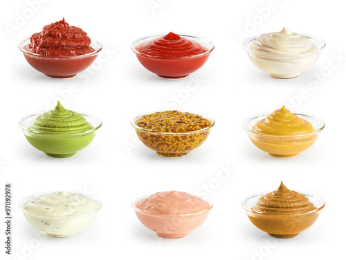 Bowls with sauces ketchup and mustard on white background. photo