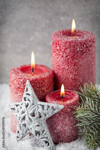 Three red candles on gray background  Christmas decoration. Adve