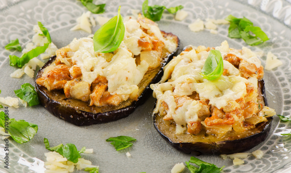 Baked eggplant with chanterelles, cheese and fresh basil.