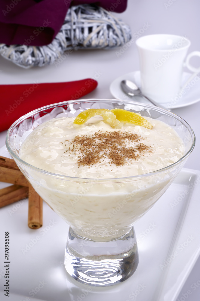 Cup of rice pudding with cinnamon and lemon peel
