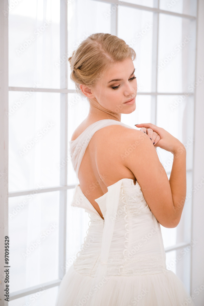 Bride putting on her white wedding dress Bride putting on her white wedding dress