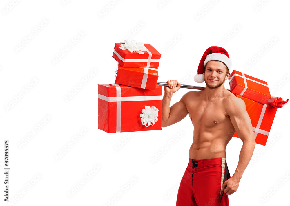 Santa body secrets. Portrait of a young fit stud with muscular body smiling happily carrying presents Santa body secrets. Portrait of a young fit stud with muscular body smiling happily carrying presents