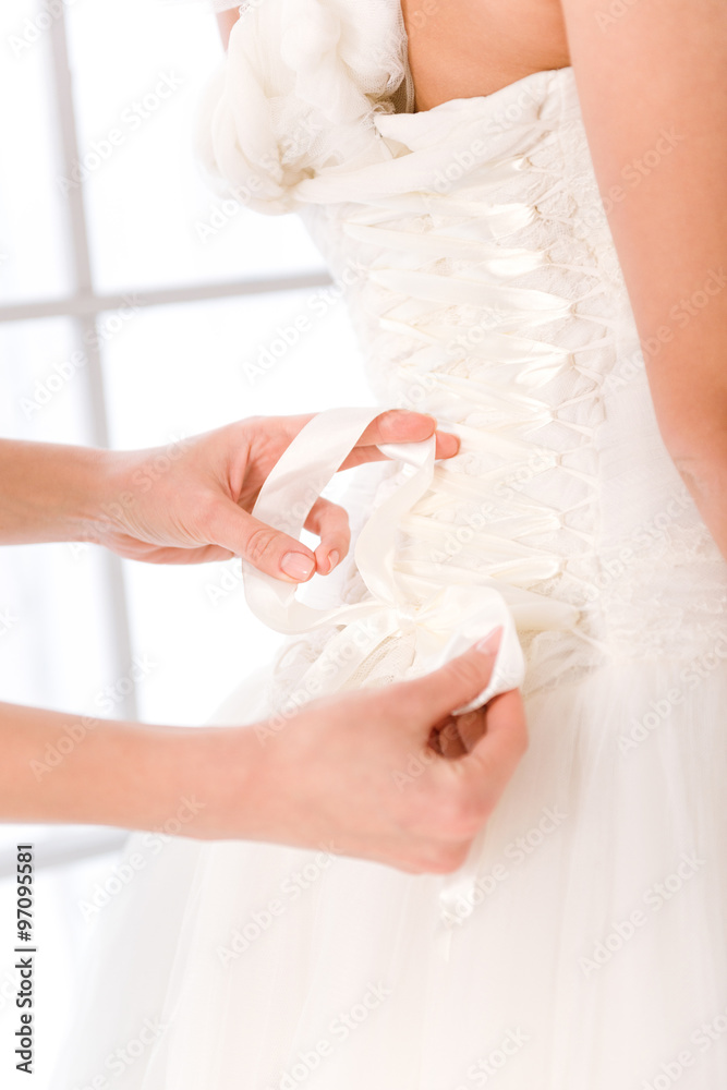 Bride putting white wedding dress Bride putting white wedding dress
