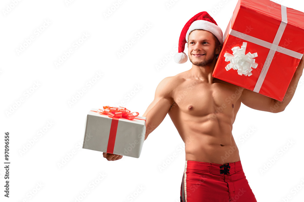 I want you to take this. Halflenght studio portrait of a gorgeous sexy Santa Claus holding out a gift box and looking away smiling joyfully I want you to take this. Halflenght studio portrait of a gorgeous sexy Santa Claus holding out a gift box and looking away smiling joyfully
