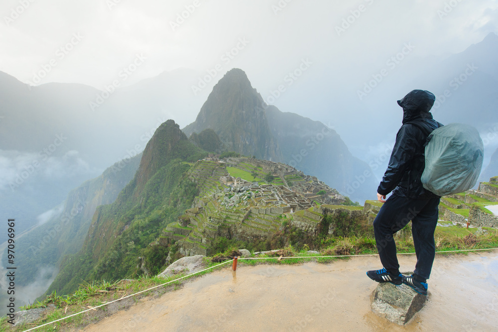 Tourist looking over Machu Picchu, Peru Tourist looking over Machu Picchu, Peru