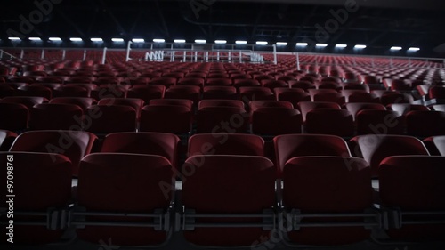 Camera dollies out to reveal empty seats in a basketball arena