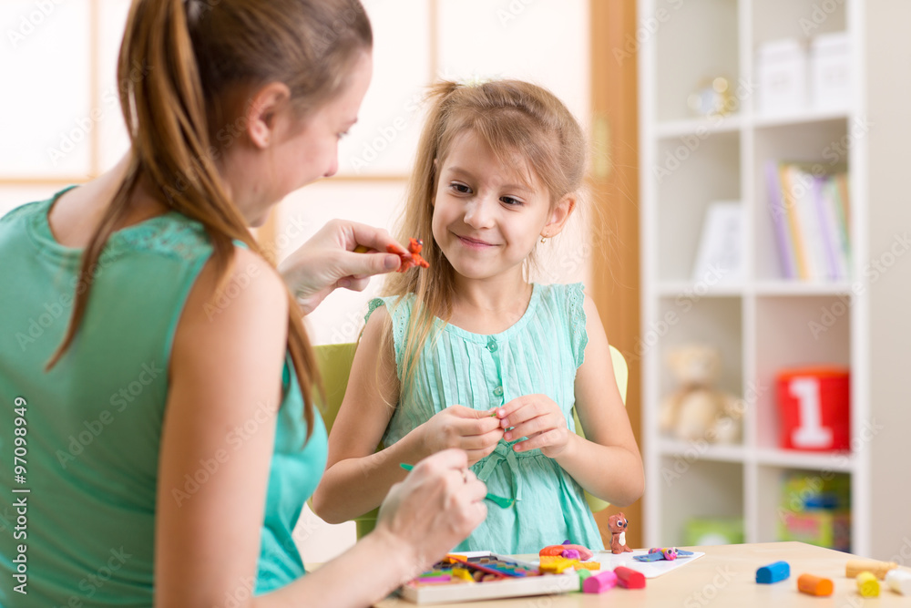 kid girl and mother play colorful clay toys at nursery at home kid girl and mother play colorful clay toys at nursery at home