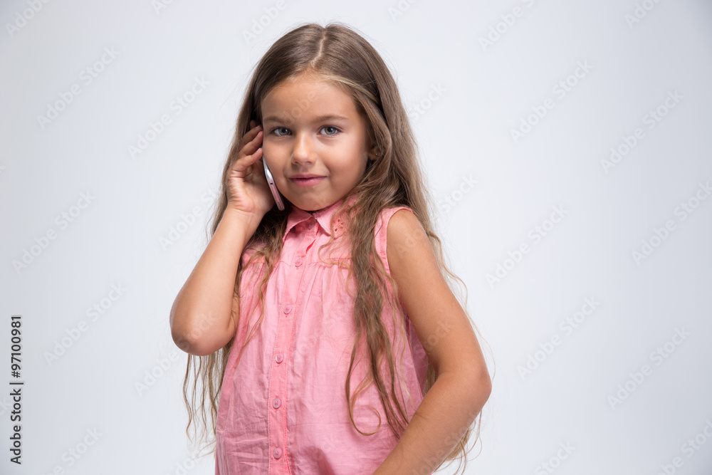 Portrait of a happy little girl talking on the phone Portrait of a happy little girl talking on the phone