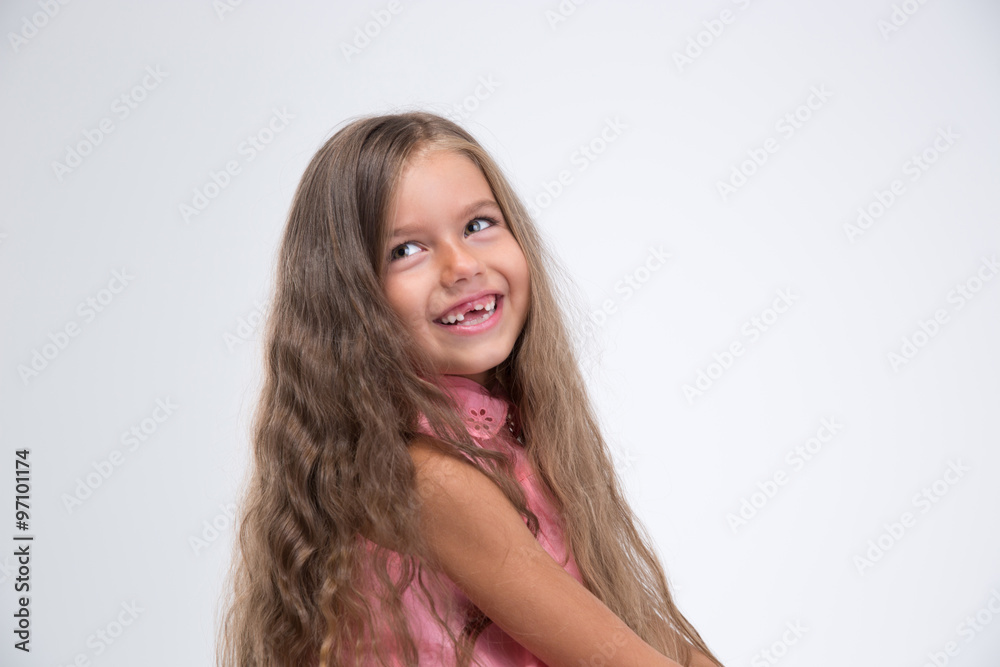 Portrait of a laughing little girl looking away Portrait of a laughing little girl looking away