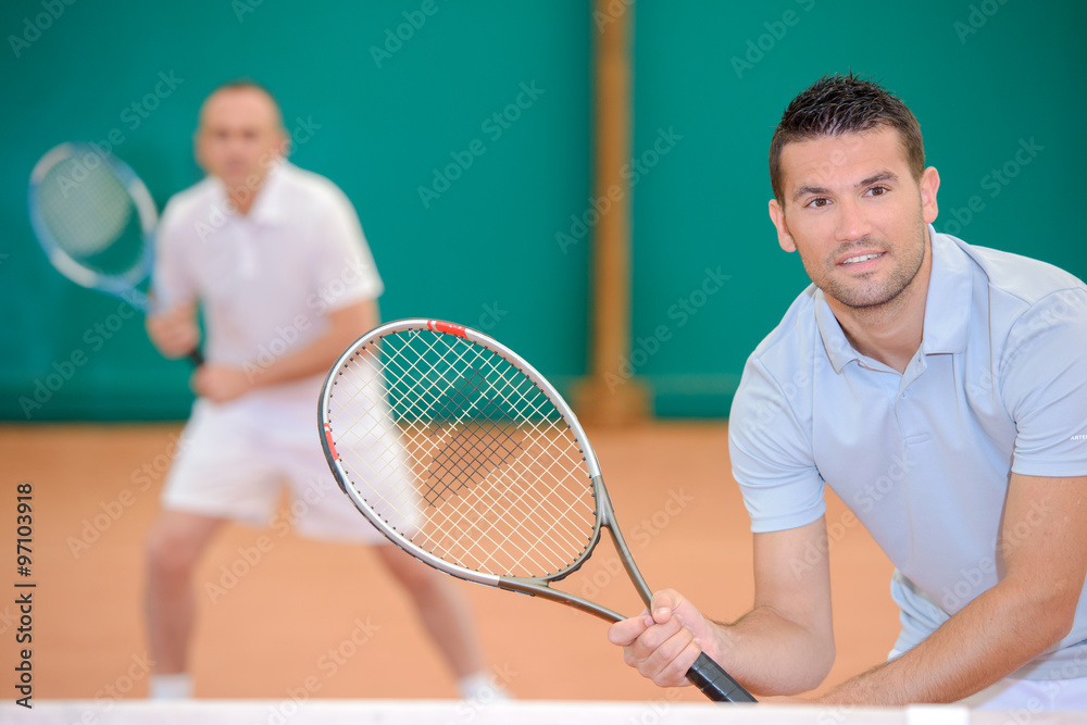 Two men poised for a game of tennis