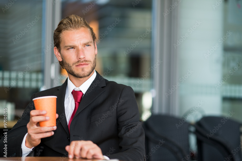 Handsome businessman drinking a cup of coffee