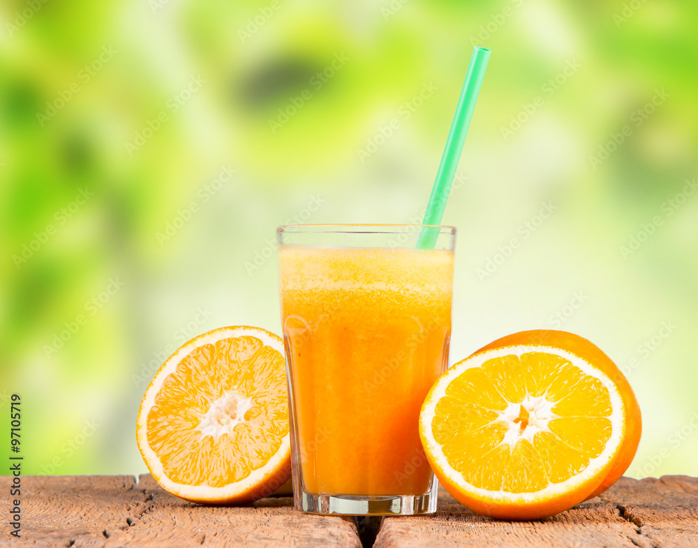 Glass of orange juice with vegetables on table Glass of orange juice with vegetables on table
