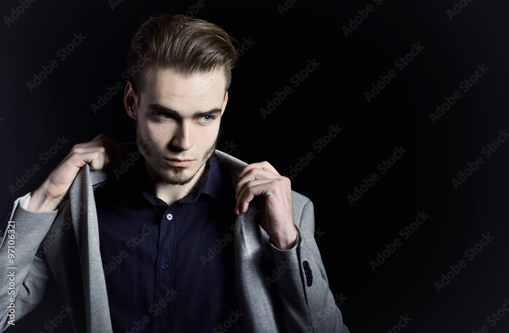 Portrait of attractive mysterious young man over black backgroun Portrait of attractive mysterious young man over black backgroun