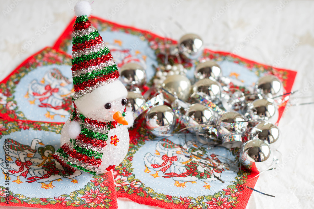 Selective focus of little snowman with Christmas decorations