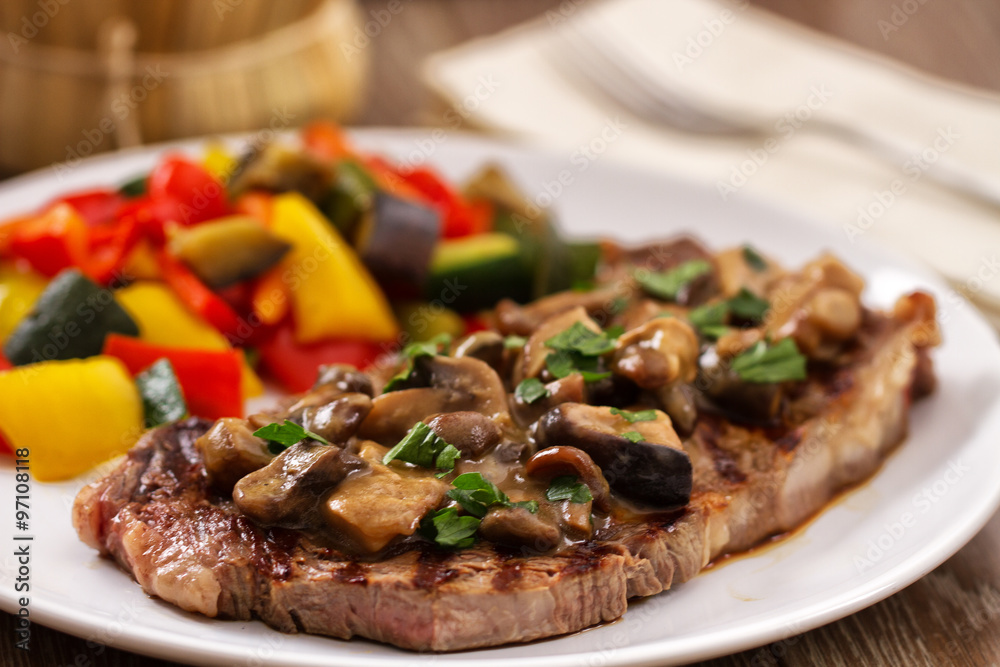 Grilled beefsteak with mushrooms and mixed vegetables. Grilled beefsteak with mushrooms and mixed vegetables.