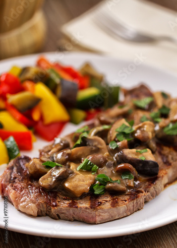 Grilled beefsteak with mushrooms and mixed vegetables.