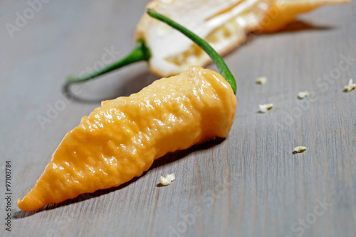 naga jolokia yellow on wooden background photo