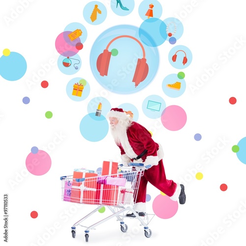 Composite image of santa pushing a shopping cart photo