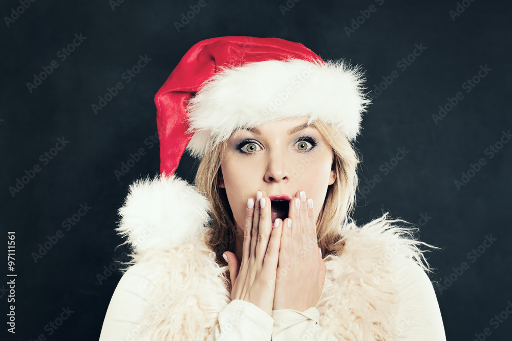 Surprised Woman in Santa Hat Having Fun. Christmas Sale Concept. Surprised Woman in Santa Hat Having Fun. Christmas Sale Concept.