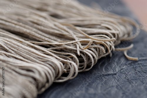 Squid ink pasta on wooden board