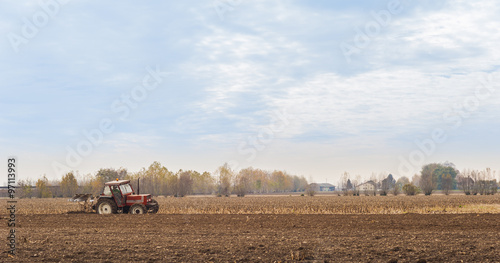 Red Tractor Plowing in Autumn © Franco Nadalin