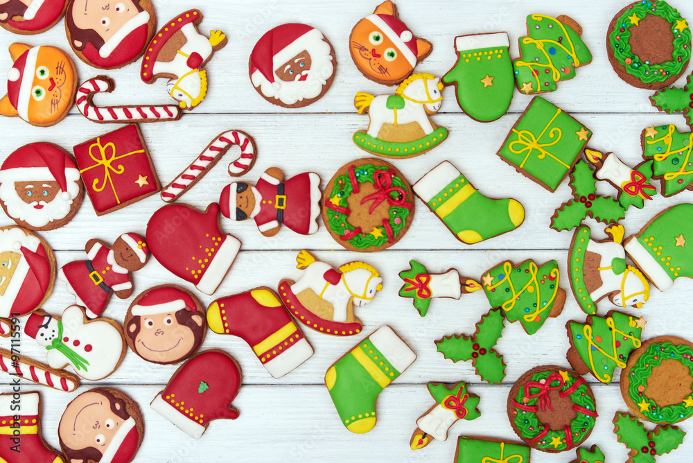 Christmas green and red gingerbread cookies on wooden background
