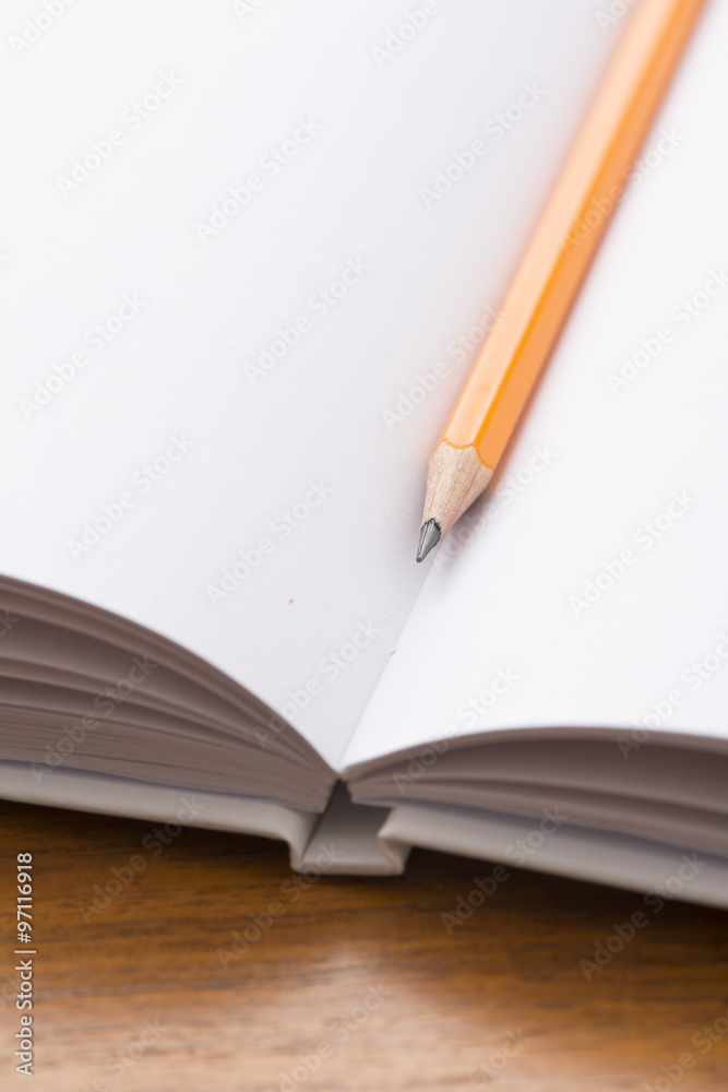 Empty notebook and yellow pencil Empty notebook and yellow pencil