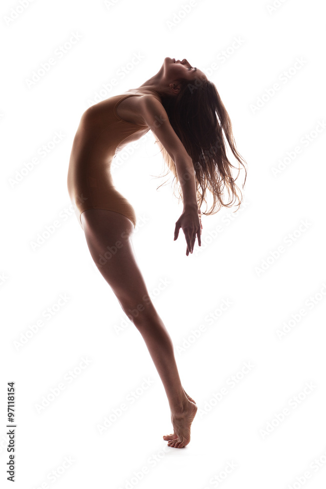 Naklejka premium young beautiful dancer in beige swimsuit posing