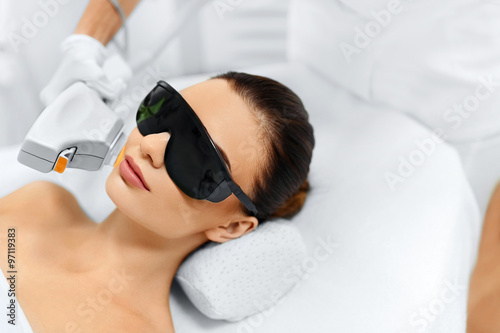 Skin Care. Young Woman Receiving Facial Beauty Treatment, Removing Pigmentation At Cosmetic Clinic. Intense Pulsed Light Therapy. IPL. Rejuvenation, Photo Facial Therapy. Anti-aging Procedures. photo