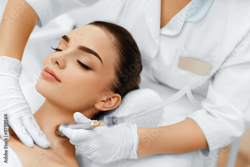 Face Skin Care. Closeup Of Beautiful Woman Getting Diamond Microdermabrasion Peeling Treatment In A Beauty Spa Salon. Cleansing Procedure. Cosmetology. 