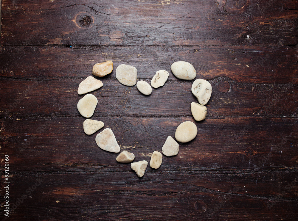 A heart shaped pebble stones on a old wood planks A heart shaped pebble stones on a old wood planks