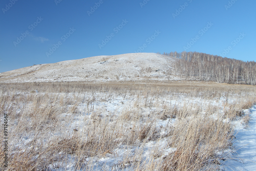 View of a hill Bald covered with snow,Bugotaksky hills, the Novosibirsk region, Russia