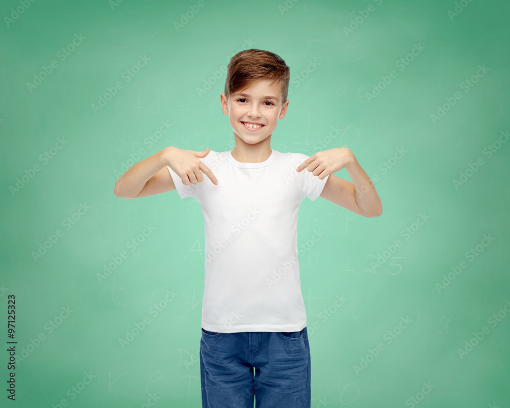 happy boy pointing finger to his white t-shirt
