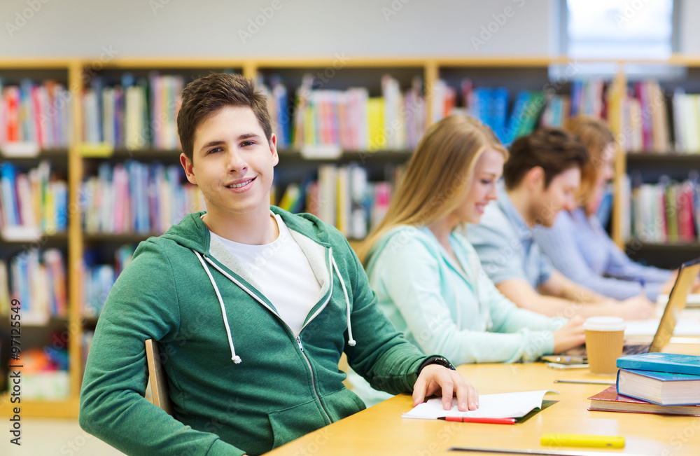 happy student boy reading books in library happy student boy reading books in library