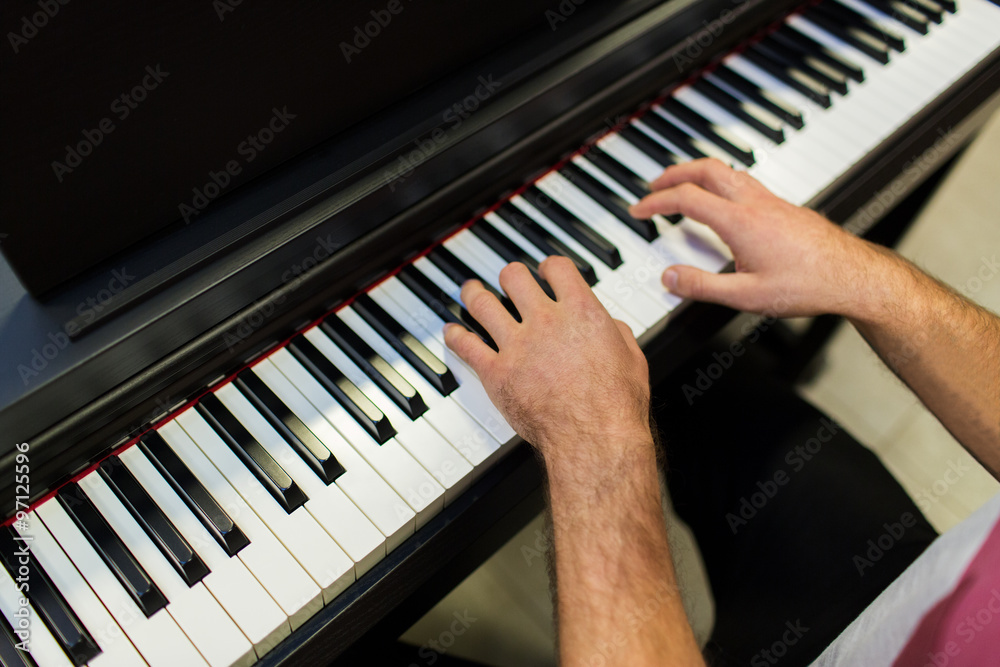 close up of male hands playing piano close up of male hands playing piano