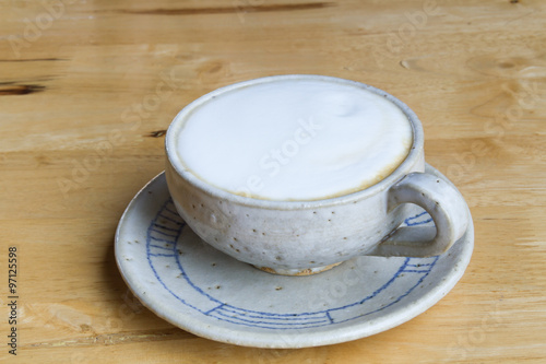Close up Vintage cup of Coffee, latte on wooden background