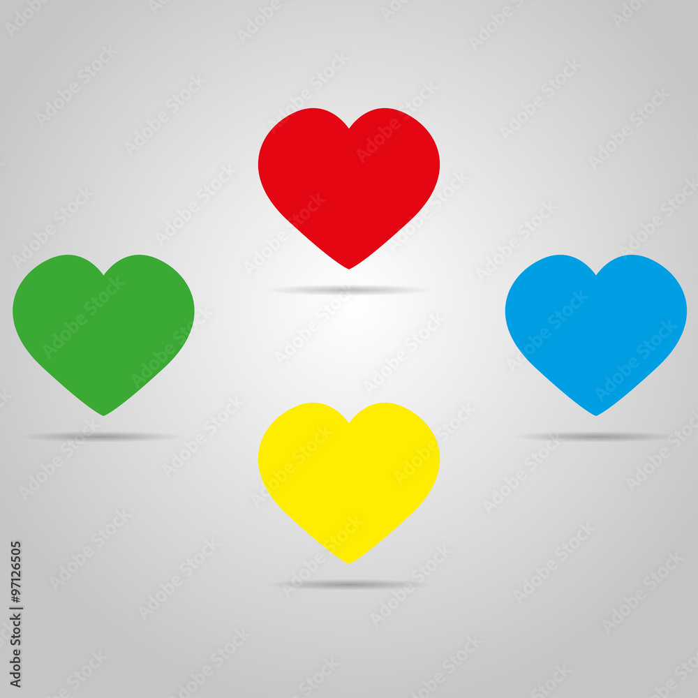 Four colored hearts with shadow on a grey color